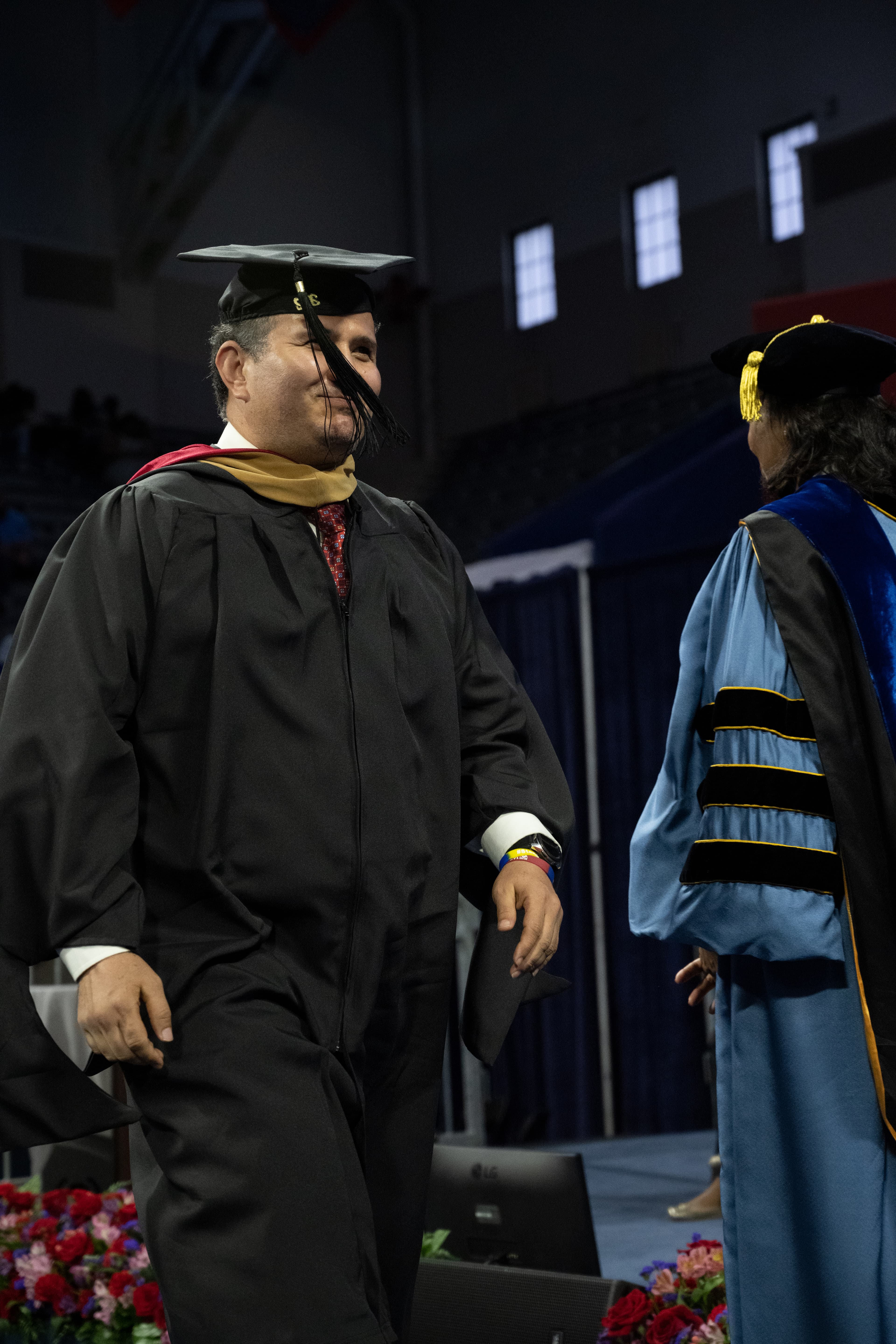 Mosa Rahimi crossing the stage at his Wharton MBA graduation